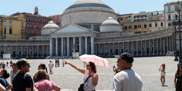 NAPLES, ITALY - JULY 11: A woman uses an umbrella to shield herself from the sun during the African heatwave in Naples on July 11, 2026. A new and more intense heatwave is sweeping across Italy and Western Europe, with temperatures peaking at 38-41 degrees celsius in southern Italy. (Photo by Eliano Imperato/Anadolu via Getty Images)