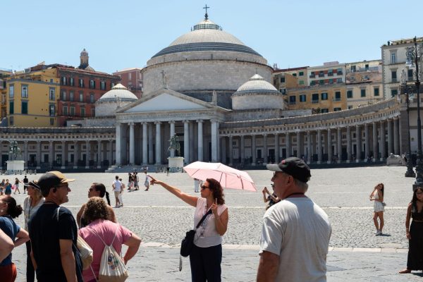 NAPLES, ITALY - JULY 11: A woman uses an umbrella to shield herself from the sun during the African heatwave in Naples on July 11, 2026. A new and more intense heatwave is sweeping across Italy and Western Europe, with temperatures peaking at 38-41 degrees celsius in southern Italy. (Photo by Eliano Imperato/Anadolu via Getty Images)