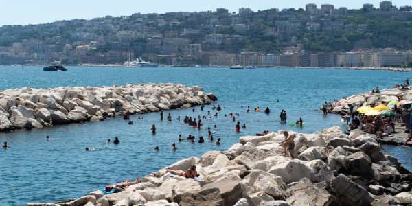 NAPLES, ITALY - JULY 11: People sunbath and swim during the African heatwave in Naples on July 11, 2026. A new and more intense heatwave is sweeping across Italy and Western Europe, with temperatures peaking at 38-41 degrees celsius in southern Italy. (Photo by Eliano Imperato/Anadolu via Getty Images)