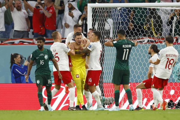 AL RAYYAN, QATAR - NOVEMBER 26: Goalkeeper Wojciech Szczesny #1 of Poland celebrates with team mates after blocking a penalty kick by Salem Al-Dawsari #10 of Saudi Arabia during the FIFA World Cup Qatar 2022 Group C match between Poland and Saudi Arabia at Education City Stadium on November 26, 2022 in Al Rayyan, Qatar. (Photo by Fu Tian/China News Service via Getty Images)