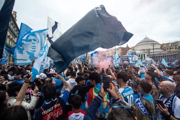 NAPLES, ITALY - APRIL 30: Supporters of Napoli celebrate the defeat of Lazio to Inter Milan on April 30, 2023 in Naples, Italy. The city of Naples is preparing to celebrate the victory of the third Scudetto in the Serie A championship. In the streets of the historic center and in the various districts of Naples, decorations, flags and banners have been set up which celebrate the football championship played by the team coached by Spalletti. Napoli could become champions of Italy in advance, if they beat Salernitana at the Campania derby on Sunday at 3 pm at the Diego Armando Maradona Stadium, and in the event that Lazio fail to win away against Internazionale. Napoli has won two Scudetti in its history in the 1986-1987 and 1989-1990 seasons, both victories were obtained with the presence of late football legend Diego Armando Maradona, the Neapolitan fans are awaiting to celebrate 33 years after the last success (Photo by Ivan Romano/Getty Images)