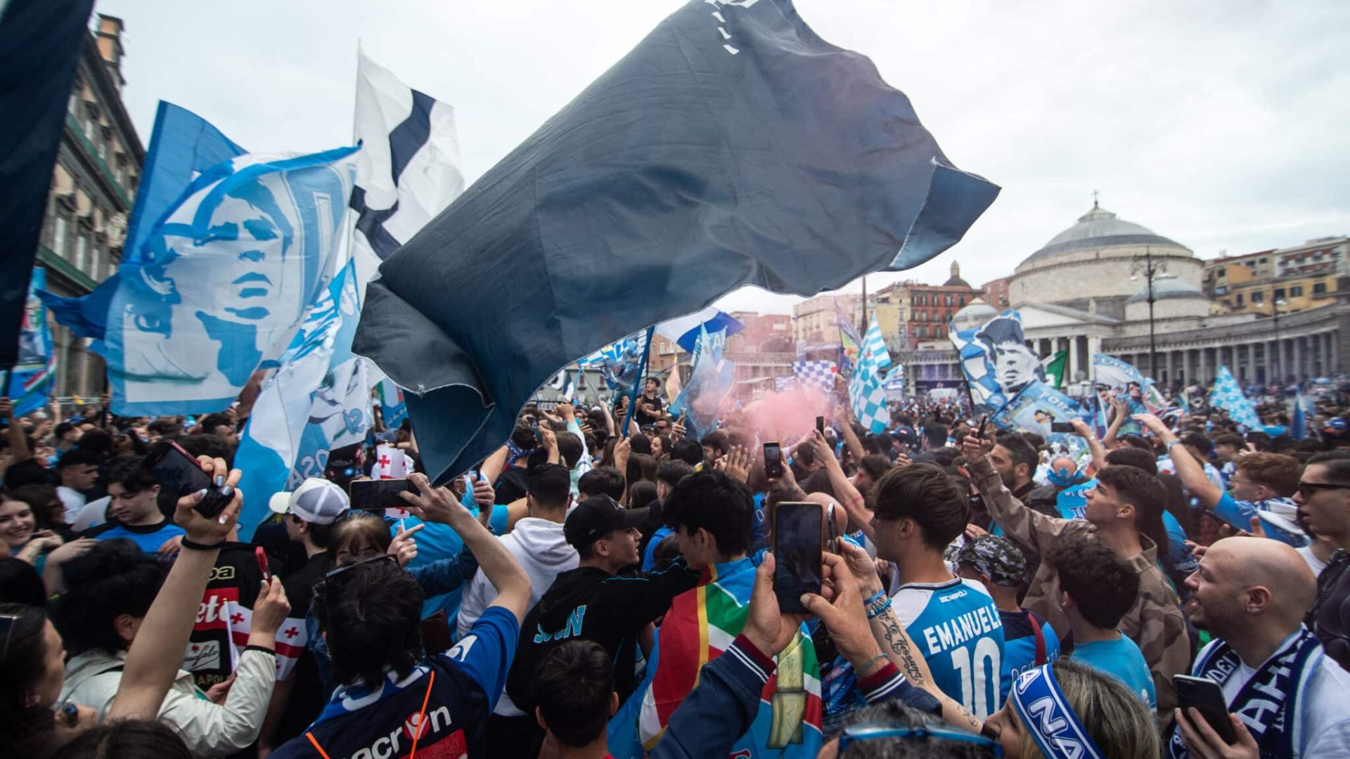 NAPLES, ITALY - APRIL 30: Supporters of Napoli celebrate the defeat of Lazio to Inter Milan on April 30, 2023 in Naples, Italy. The city of Naples is preparing to celebrate the victory of the third Scudetto in the Serie A championship. In the streets of the historic center and in the various districts of Naples, decorations, flags and banners have been set up which celebrate the football championship played by the team coached by Spalletti. Napoli could become champions of Italy in advance, if they beat Salernitana at the Campania derby on Sunday at 3 pm at the Diego Armando Maradona Stadium, and in the event that Lazio fail to win away against Internazionale. Napoli has won two Scudetti in its history in the 1986-1987 and 1989-1990 seasons, both victories were obtained with the presence of late football legend Diego Armando Maradona, the Neapolitan fans are awaiting to celebrate 33 years after the last success (Photo by Ivan Romano/Getty Images)