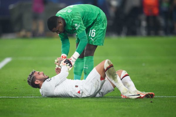 DORTMUND, GERMANY - OCTOBER 04: Mike Maignan of Milan helps Theo Hernandez stand up during the UEFA Champions League match between Borussia Dortmund and AC Milan at Signal Iduna Park on October 04, 2023 in Dortmund, Germany. (Photo by Edith Geuppert - GES Sportfoto/Getty Images)