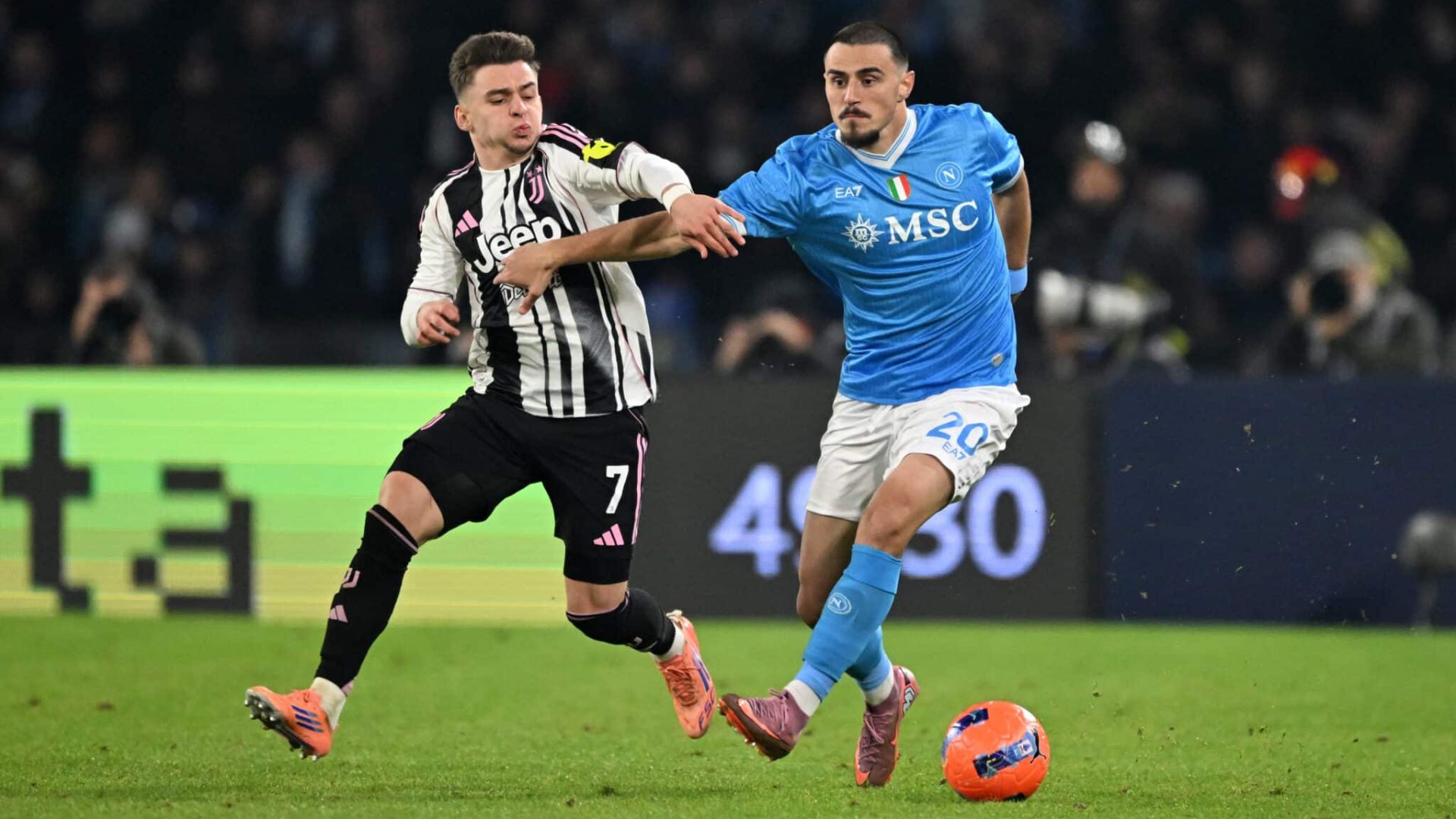 NAPLES, ITALY - DECEMBER 07: Eljif Elmas of SSC Napoli runs with the ball whilst under pressure from Francisco Conceicao of Juventus during the Serie A match between SSC Napoli and Juventus FC at Stadio Diego Armando Maradona on December 07, 2025 in Naples, Italy. (Photo by Francesco Pecoraro/Getty Images)