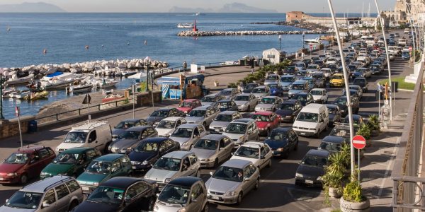 Morning rush hour traffic jam along the Via Nazario Sauro in Naples, Italy. with the Bay of Naples beyond.