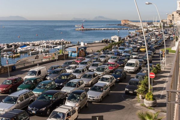 Morning rush hour traffic jam along the Via Nazario Sauro in Naples, Italy. with the Bay of Naples beyond.