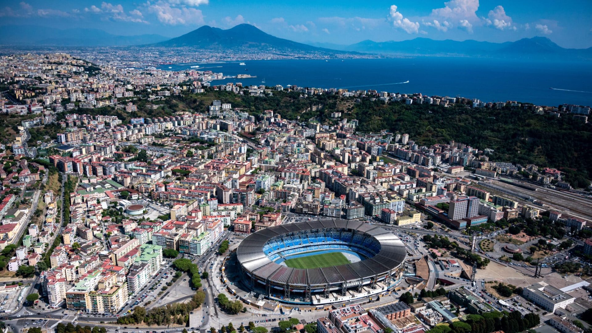 NAPLES, ITALY - SEPTEMBER 05: Aerial view, from a helicopter, of the city with the Diego Armando Maradona stadium and the Bay of Naples and Vesuvius in the background on September 05, 2019 in NAPLES Italy. Italy's nearly 8000 km (5,000 miles) coastlines and islands stretch across the Mediterranean Sea and attract large numbers of both local and foreign tourists during the summer season. (Photo by Fabrizio Villa/Getty Images)