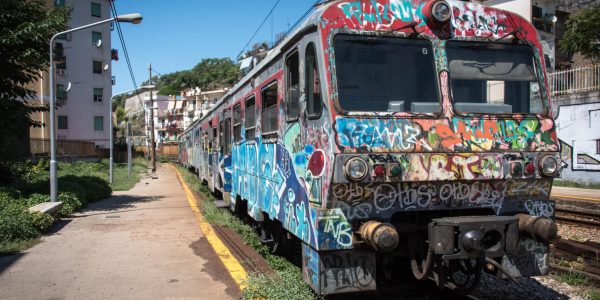A train covered with graffiti stops at the Gerolomini station in Pozzuoli, italy on 23 August 2015. (Photo by Diego Cupolo/NurPhoto via Getty Images)