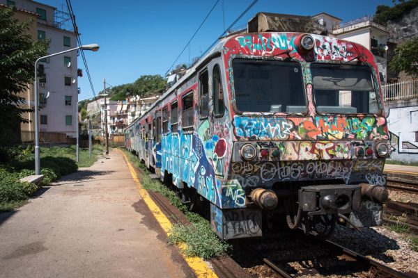A train covered with graffiti stops at the Gerolomini station in Pozzuoli, italy on 23 August 2015. (Photo by Diego Cupolo/NurPhoto via Getty Images)