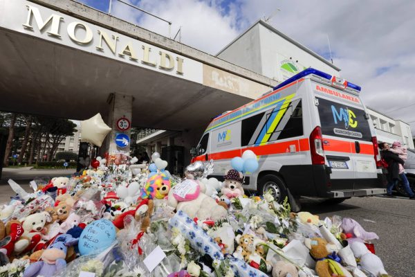NAPLES, CAMPANIA, ITALY - 2026/02/24: An ambulance passes stuffed animals and flowers at the entrance to Monaldi Hospital in Naples, for two-year-old Domenico Caliendo, who received a damaged heart transplant. Domenico Caliendo received the heart of Moritz Gerstl, a four-year-old boy who died in Bolzano, northern Italy, on December 23, 2025, but the organ was damaged during transport, investigators said. Six members of the surgical team that operated on Domenico Caliendo are under investigation. (Photo by Salvatore Laporta/KONTROLAB/LightRocket via Getty Images)