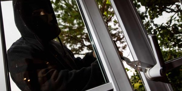 28 August 2020, Baden-Wuerttemberg, Freiburg: ILLUSTRATION - A man mimes a burglar and uses a crowbar to pry open a tilted patio door. Due to temporary curfews, the loss of cultural activities and home office, more people were at home, making it more difficult for burglars to get in. Photo: Philipp von Ditfurth/dpa (Photo by Philipp von Ditfurth/picture alliance via Getty Images)