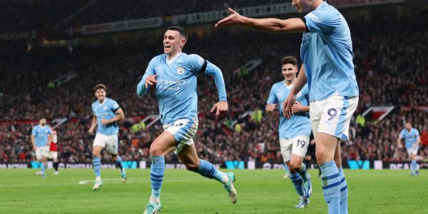 MANCHESTER, ENGLAND - OCTOBER 29: Phil Foden of Manchester City celebrates alongside teammate Erling Haaland after scoring the team's third goal during the Premier League match between Manchester United and Manchester City at Old Trafford on October 29, 2023 in Manchester, England. (Photo by Catherine Ivill/Getty Images)