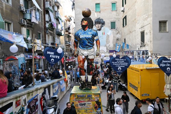 dpatop - 04 November 2025, Italy, Neapel: The "Largo Maradona" in the Quartieri Spagnoli, with its famous mural and sculpture of Diego Armando Maradona, is a magnet for soccer fans and tourists alike. The Argentinian world champion, one of the best footballers in history, played in the city on Mount Vesuvius from 1984 to 1991 and is revered there like a saint. Maradona died on November 25, 2020. Photo: Arne Dedert/dpa (Photo by Arne Dedert/picture alliance via Getty Images)